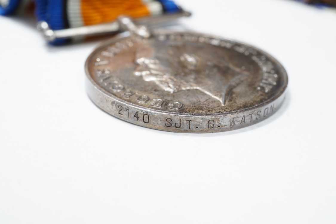 A First World War medal trio awarded to 2140 SJT. G. Watson. Argyll and Sutherland Highlanders, together with the related cap badge and two photographs of Watson in Highlanders uniform and printed as postcards